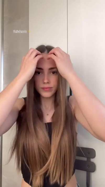 Doing her hair whilst looking hot