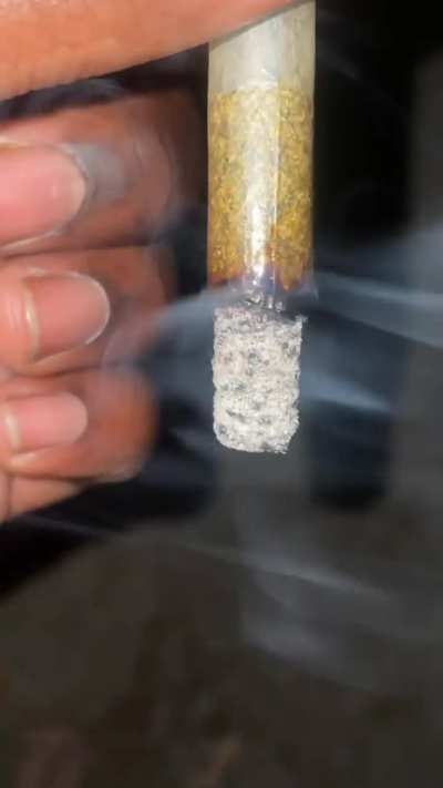 1.5 gram joint of white gummy rolled in a raw ethereal paper