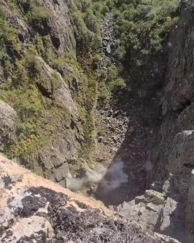 Removing loose rocks from a cliff