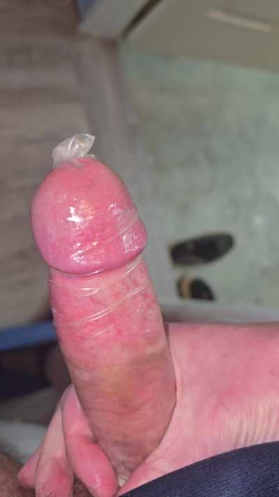 Stroking my thick cock in a tight condom