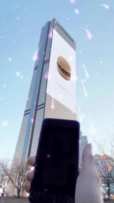 Person using phone to drag an image on a building