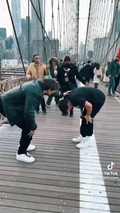 Pretending to be injured on a busy walkway for a video