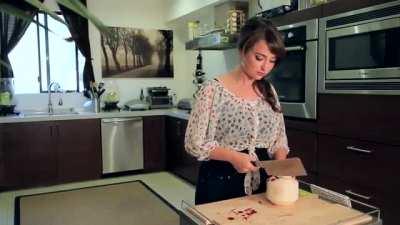 Milana Vayntrub cuts a coconut
