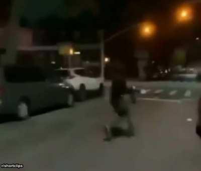 Half naked pumpkin man chased by flame throwing extinguisher with cops nearby