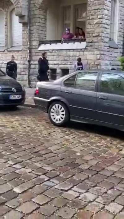 German police having a tussle with a suspect.