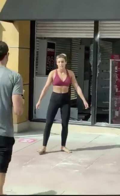 I see your woman pretending to board up windows, and I raise you a woman making her bf take a picture of her in front of looted store