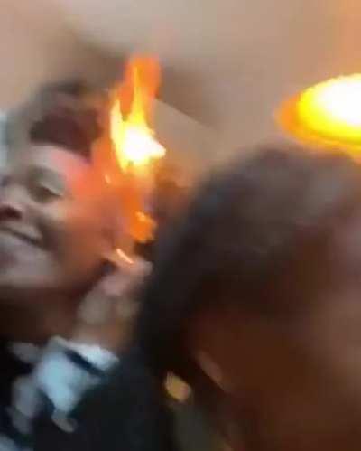 Wearing an earring that doubles as a lighter.