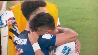 US footballer hugging Iranian player after the match