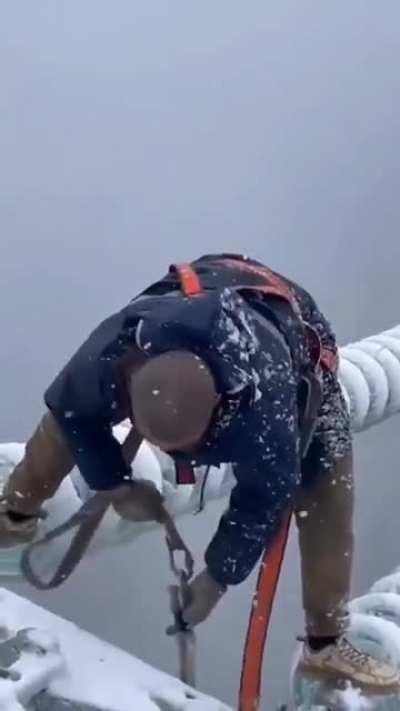 This Chinese worker, working in the middle of a storm to restore power, respect