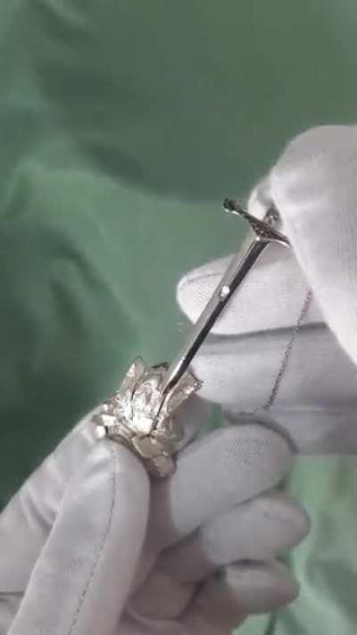 This excalibur necklace that requires pressing a hidden button on the stone to wield.. umm.. to wear.