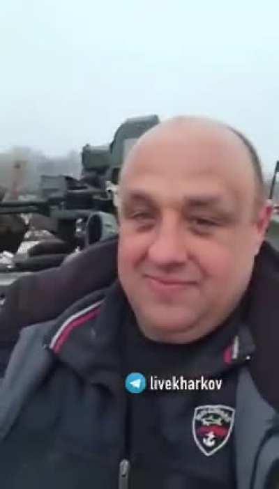 Seven Ukrainian dudes joyfully joyriding a stolen Russian tank