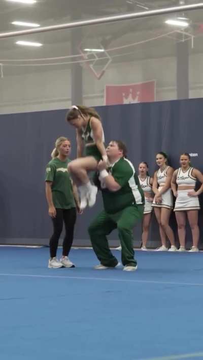 Big dude cheerleading on campus
