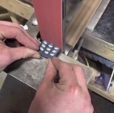 Nokia 3310 getting destroyed by belt sander