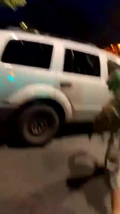 Protester ran over by a car