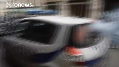 Paris protesters set police car on fire with 2 officers inside