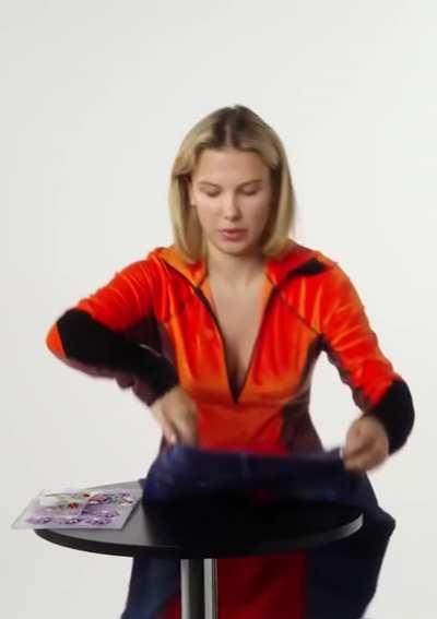 Millie Bobby Brown putting a batch on jeans