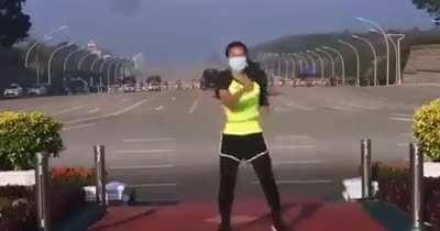 While a coup is occurring in Myanmar, a fitness instructor oblivious. Funny