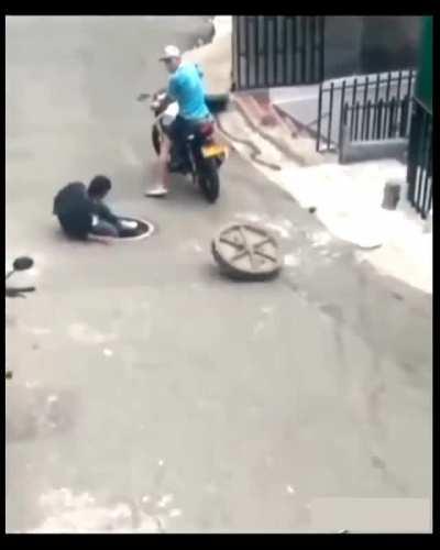 Instant regret after trying to steal a manhole cover