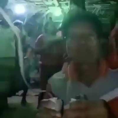 Video of man plugging and unplugging lights to keep the party going. Maybe Southeast Asian? Very fun song