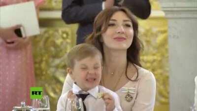 Kid tasting a lime at a ceremony