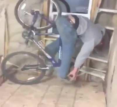 Riding down a stairs with a bicycle
