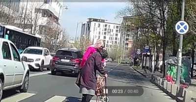 Lady in pink helps old lady