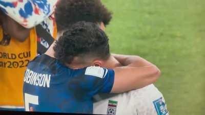 USA and Iranian Football Players Embracing Each Other After Game