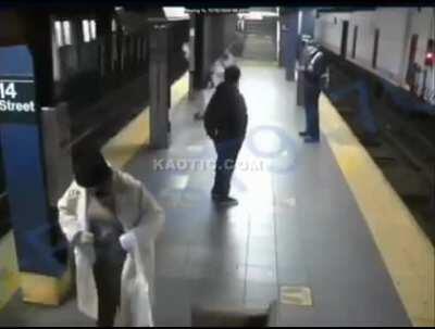 Woman pushed onto train tracks by homeless man