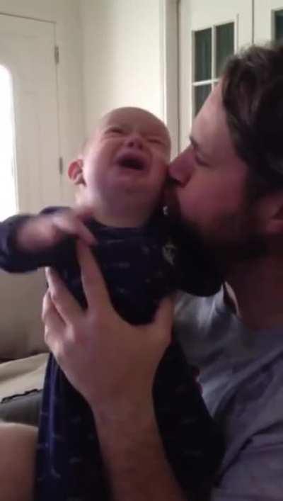 Dad calms blind and deaf son with a kiss