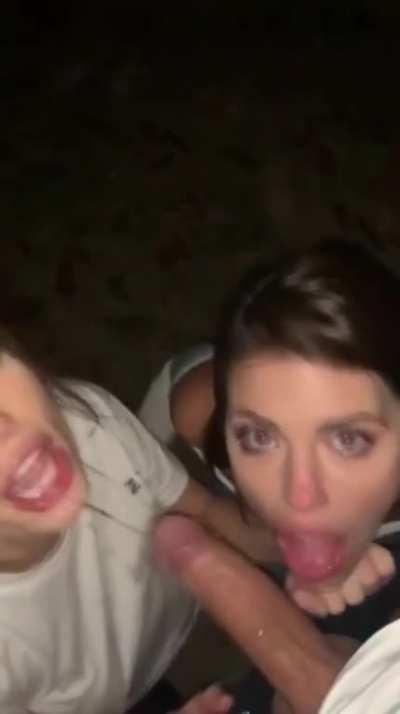 Two friends suck one dick in public