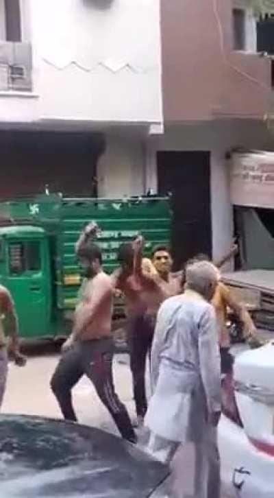 People (hooligans) harassing an elderly while celebrating Holi in India.