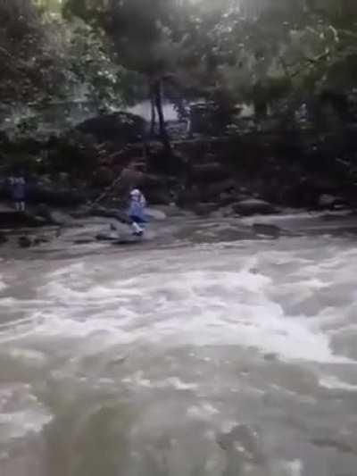 girl crossing river to reach school