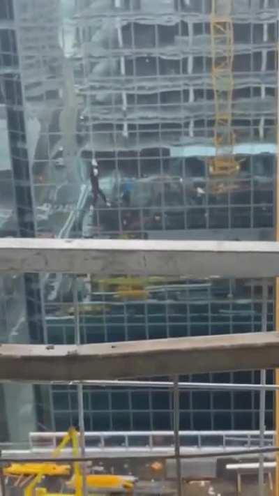 Toronto construction worker dangles from crane