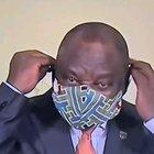 The president of South Africa putting on a face mask