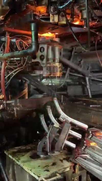 Each one of these red hot blobs are future glass bottles