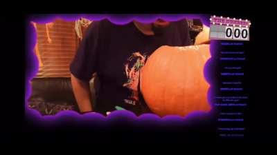 Julian carving a pumpkin