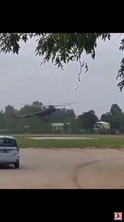 A large tarp gets pulled into the blades of a helicopter.