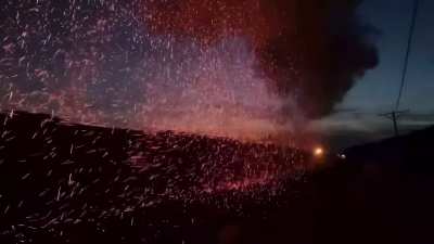 A steam locomotive ejecting cinders