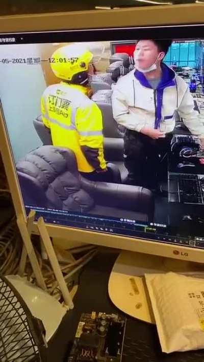 Angry gamer attempts to fight a man wearing a helmet.