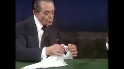Slydini doing one of his signature tricks to a talk show host Dick Cavett