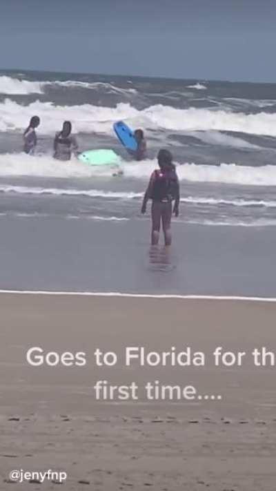 An adopted orphan goes to a beach in Florida for the first time