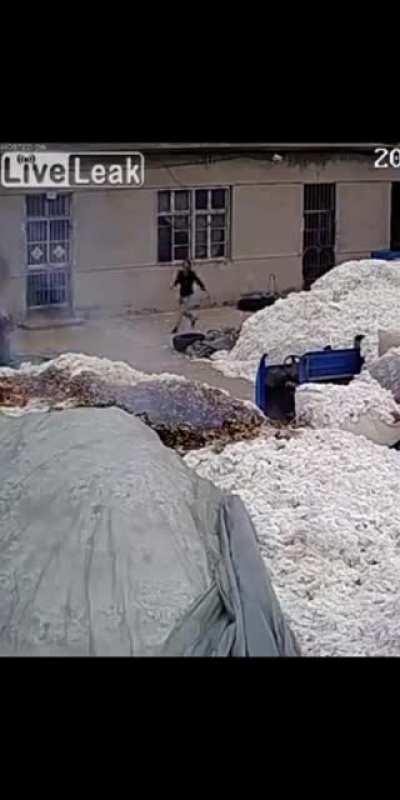 Using a lighter to open a plastic bag in a cotton warehouse
