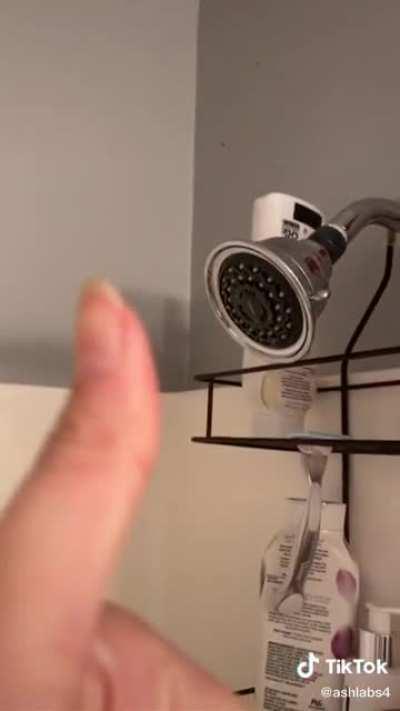 Testing the new shower head's water pressure