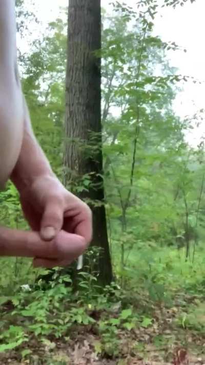 Cumming while walking in a public park