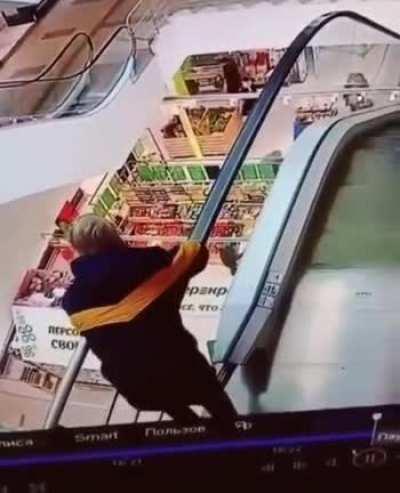 WCGW leaning on the armrest of an escalator