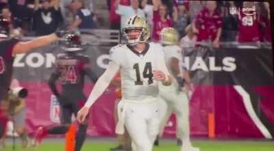 Andy Dalton not happy after throwing a pick six is photo bombed by Marco Wilson doing a flip.