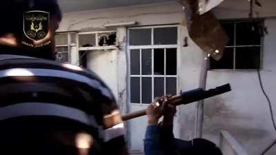Rebel fighters of the Sham al-Rasul Brigade launch grenades from a home-made catapult in Damascus, Syria (August 2013)