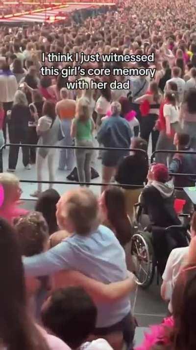 Dad and daughter at a concert, so sweet