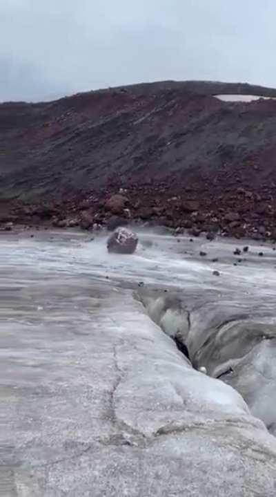 Climbers film as gigantic boulder rolls towards them on a mountainside