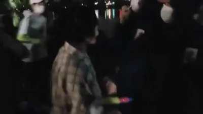 elderly woman tries to extinguish the Olympic torch with a water gun, she was arrested